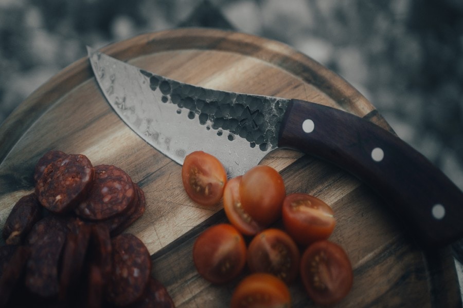 A Damascus knife in a table | How to Care for Damascus Kitchen Knives